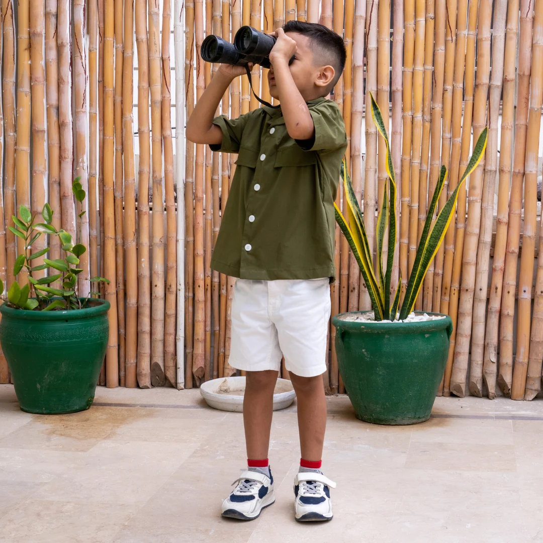 A cute kid wearing olive green cuban collar shirt from Orange