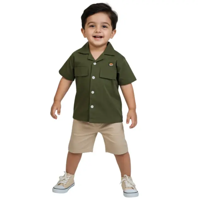 A young boy playing outdoors in the olive green Safari Shirt by Orange - premium boys shirts in Pakistan.