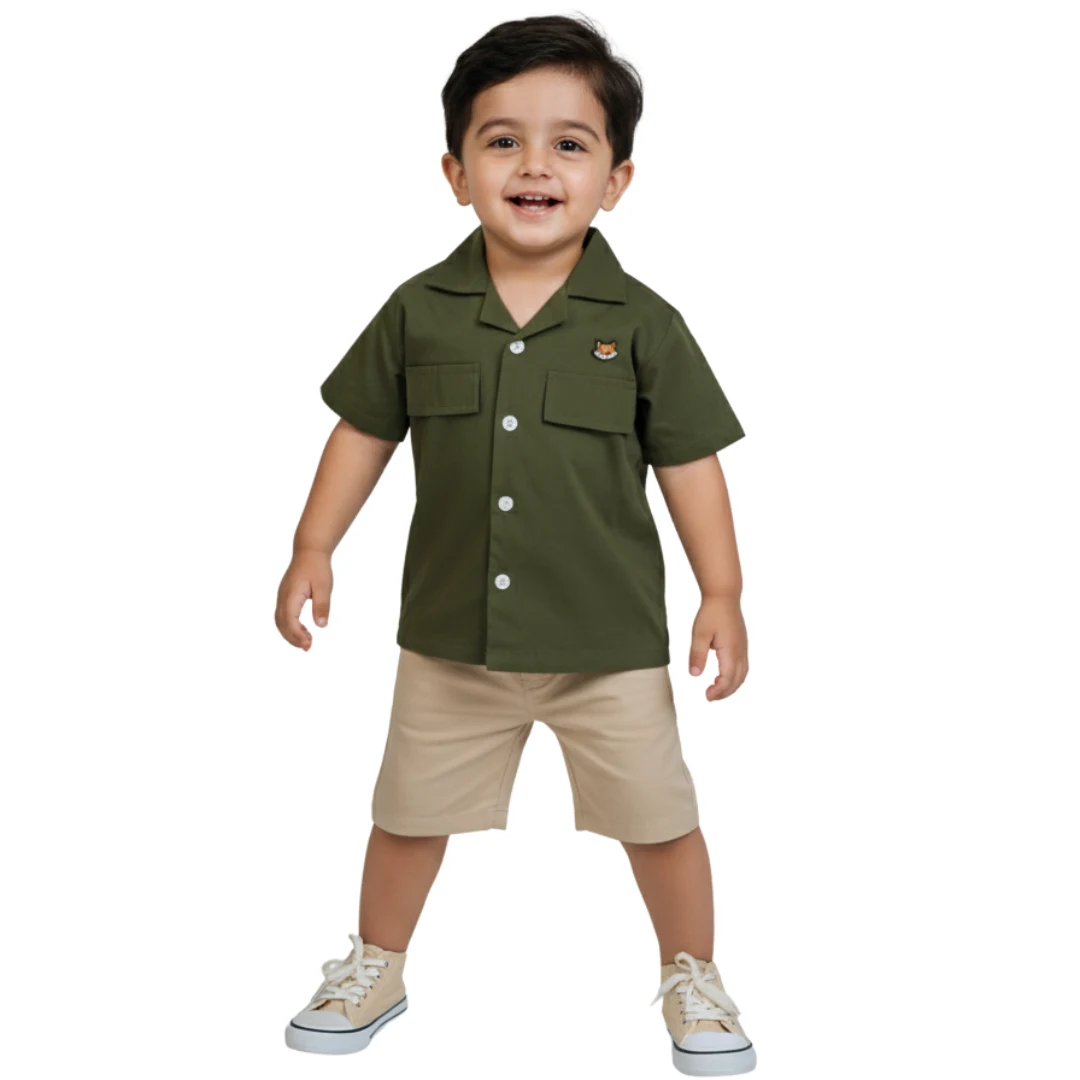 A young boy playing outdoors in the olive green Safari Shirt by Orange - premium boys shirts in Pakistan.